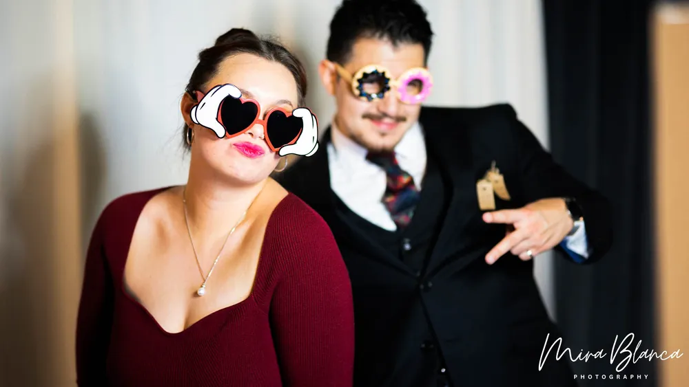 Couple enjoying Mira Blanca Photo Booth props