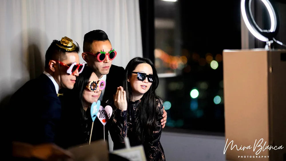 Guests posing beside the Mira Blanca Photo Booth