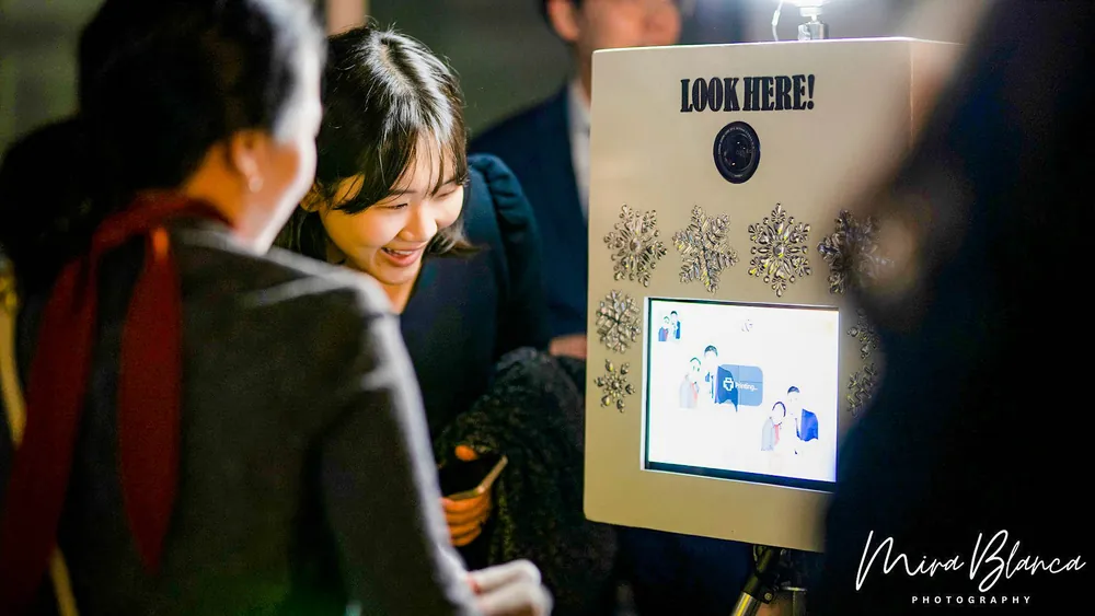 Guest using the Mira Blanca Photo Booth touchscreen