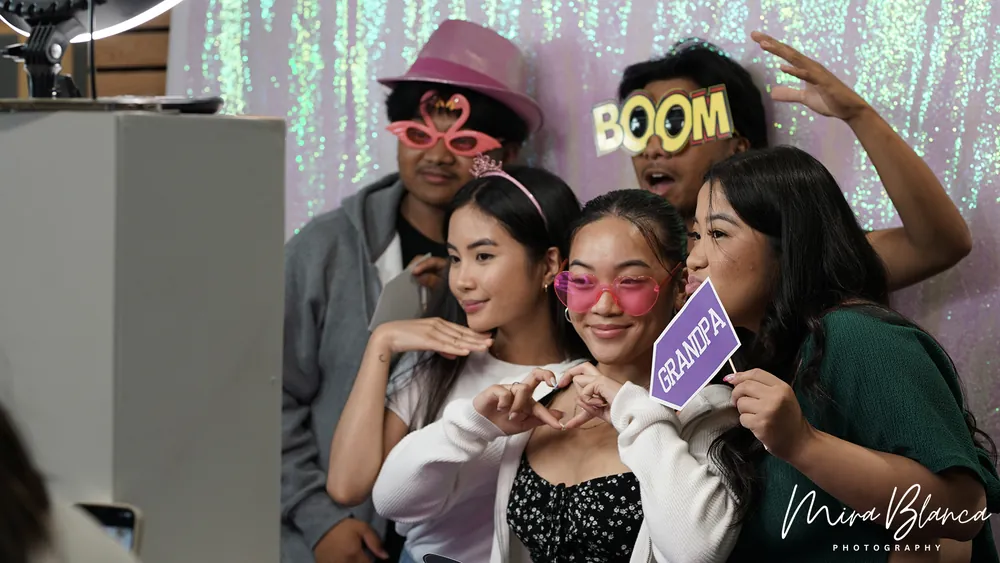 Group posing with colorful Photo Booth props