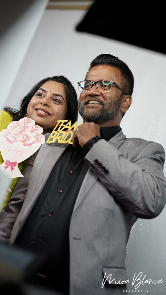 Couple posing with celebration props