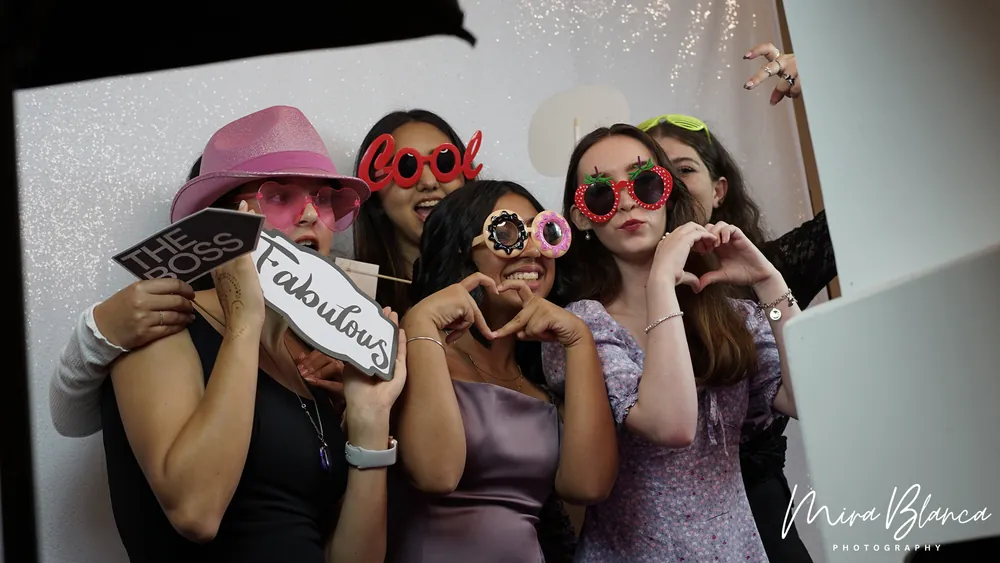 Guests posing together with Photo Booth props