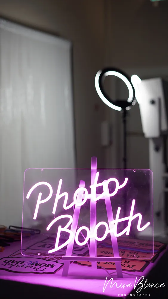 Illuminated Photo Booth sign beside the event setup