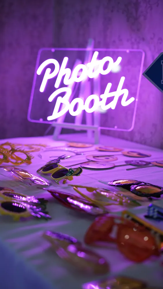 Neon Photo Booth sign above event props